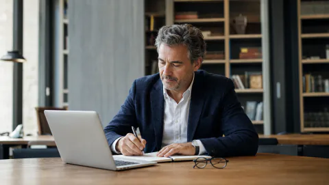 Cadre expérimenté préparant une nouvelle activité de conseil dans un espace de travail calme